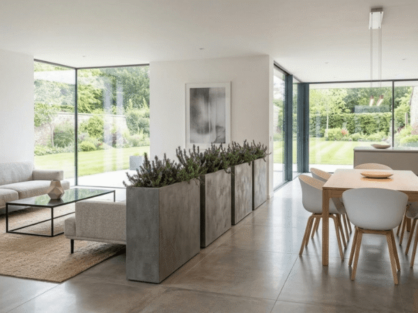 Tall planters separating zones in a modern open-plan interior.