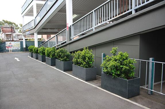 A closer view of IOTA granite trough planters