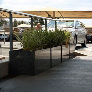 stone trough planter: IOTA Granite Planters at Parking Area