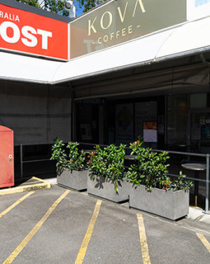 concrete planters at kova coffee and post office