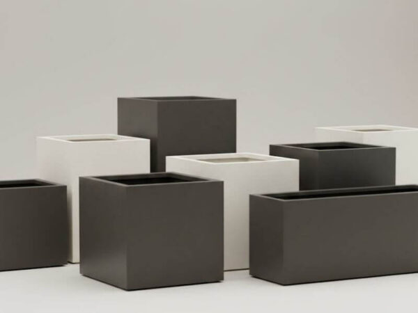 Collection of minimalist square and rectangular architectural planters in neutral finishes.