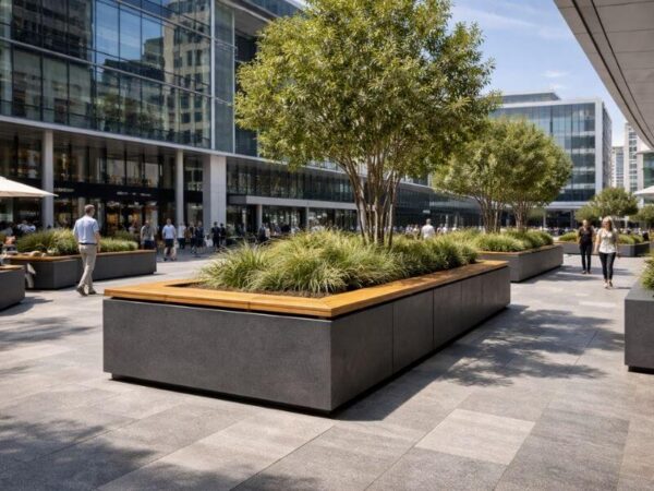 Commercial outdoor landscaping featuring large GRC rectangular planters with trees and grasses in a corporate plaza.