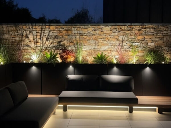 Container garden with layered nighttime lighting effects.