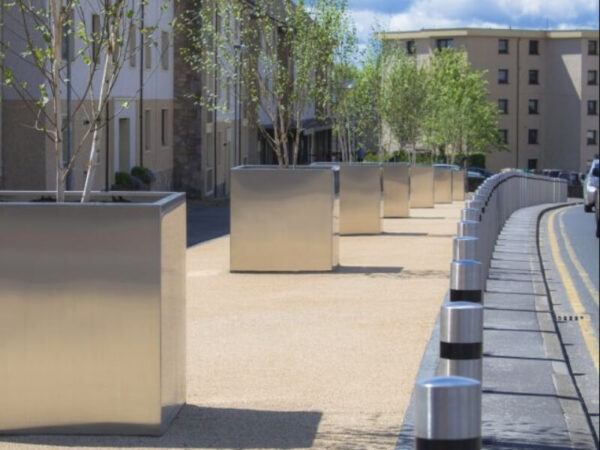 Heavy planter boxes lining a pedestrian walkway as vehicle mitigation.