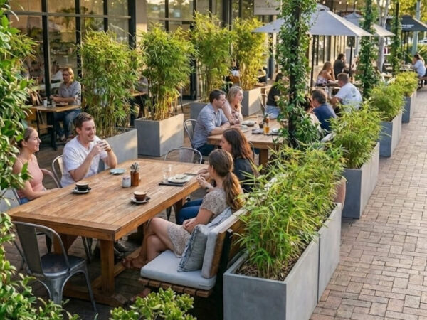 Large planters defining outdoor dining zones.