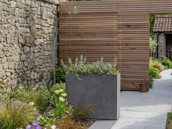 Tall concrete planter used in commercial setting