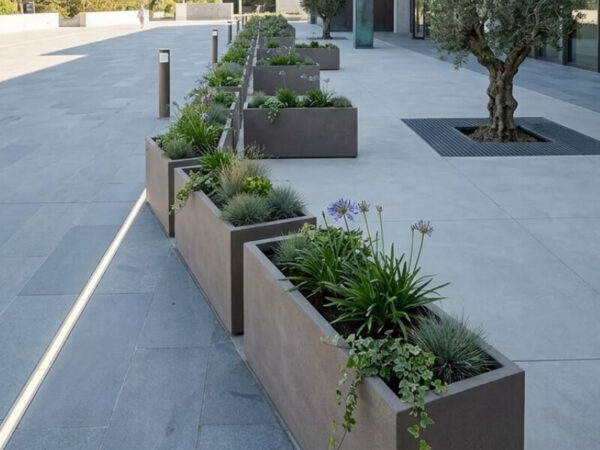 Completed installation of large trough planters in a clean commercial landscape setting