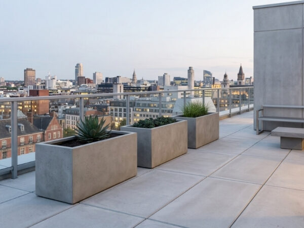 Large trough planters installed on a rooftop terrace showing structural context and minimal planting