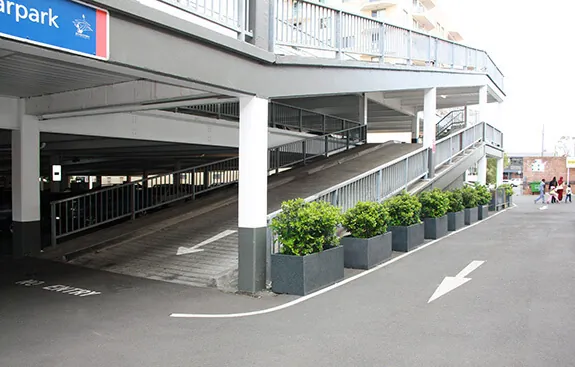 IOTA granite trough pots in parking lot