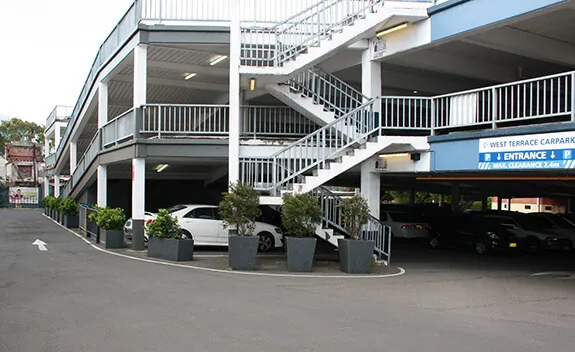 IOTA granite planters bordering a parking complex