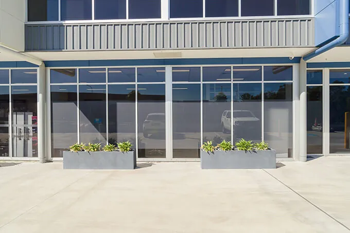 milano concrete trough planters in front of huntress warehouse close-up