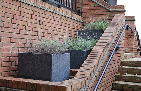 Tall Square Planters incorporated into stairway recesses. 