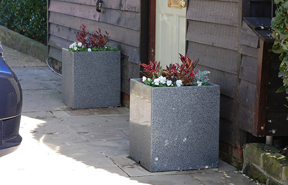 An arrangement of smaller granite planters