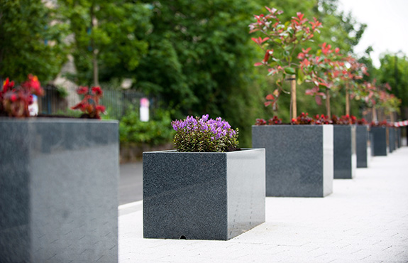 close up look of mix custom granite planters in derry park