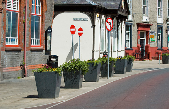 Another view of granite taper planters roadside